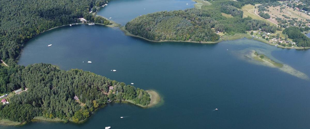 A large lake surrounded by dense forests and small islands.