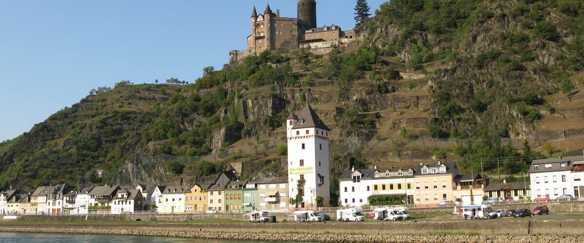 A castle on a hill, a tower, and a river.