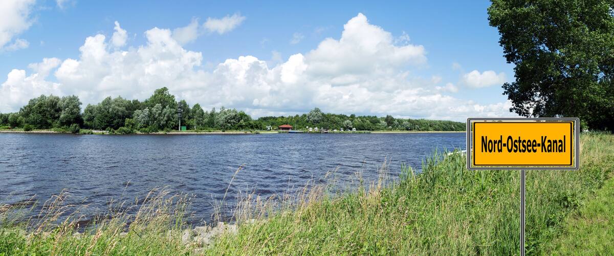 A river with a sign reading "Nord-Ostsee-Kanal".