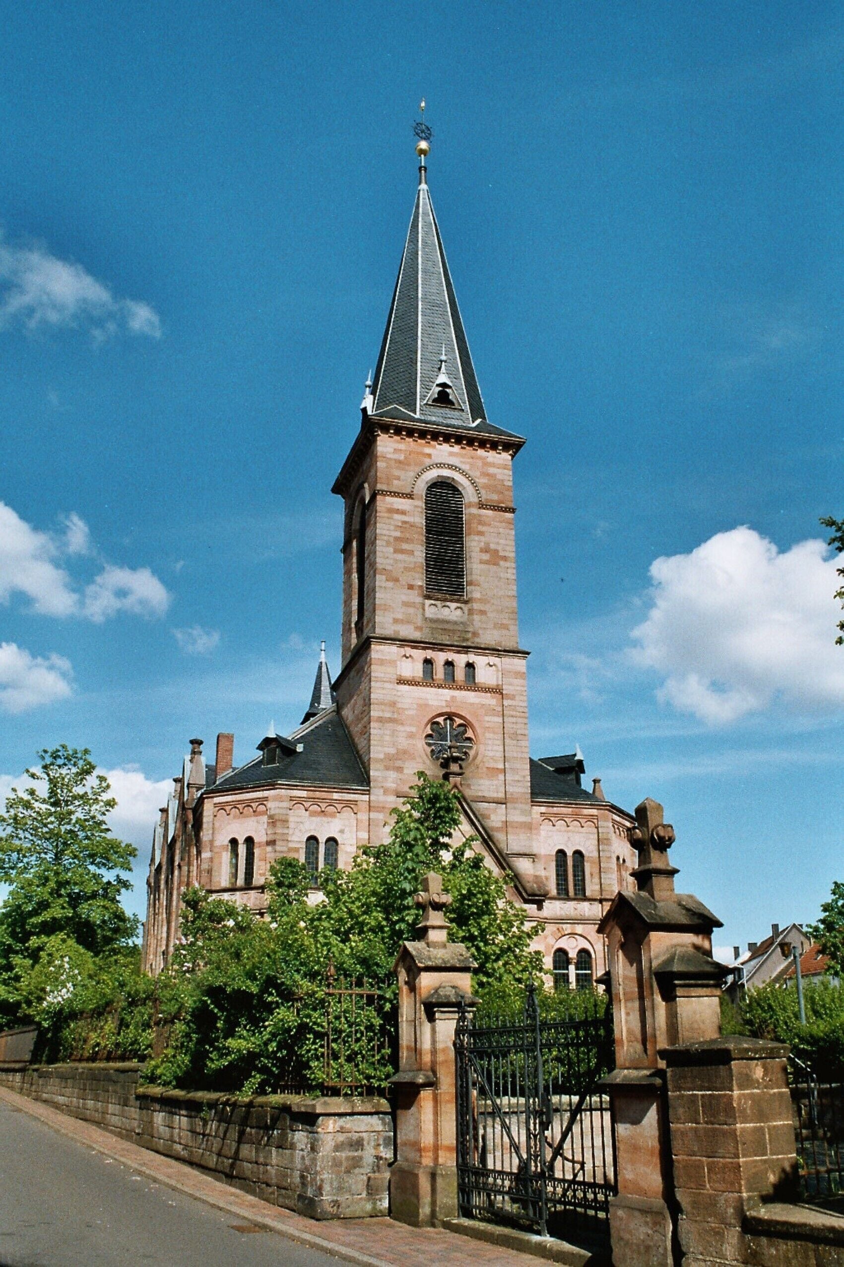 A historic church with a tall tower and a clock.
