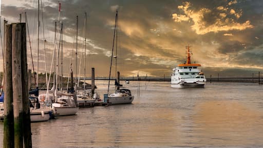 Ferry arriving in the port of Bensersiel at sunset