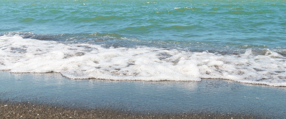 A beach with waves gently crashing onto the shore.