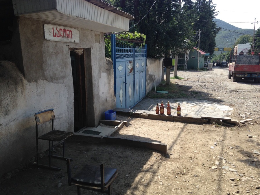 Street scene from the rural Georgian town of Bolnisi, Georgia. The building on the left is a barber shop.