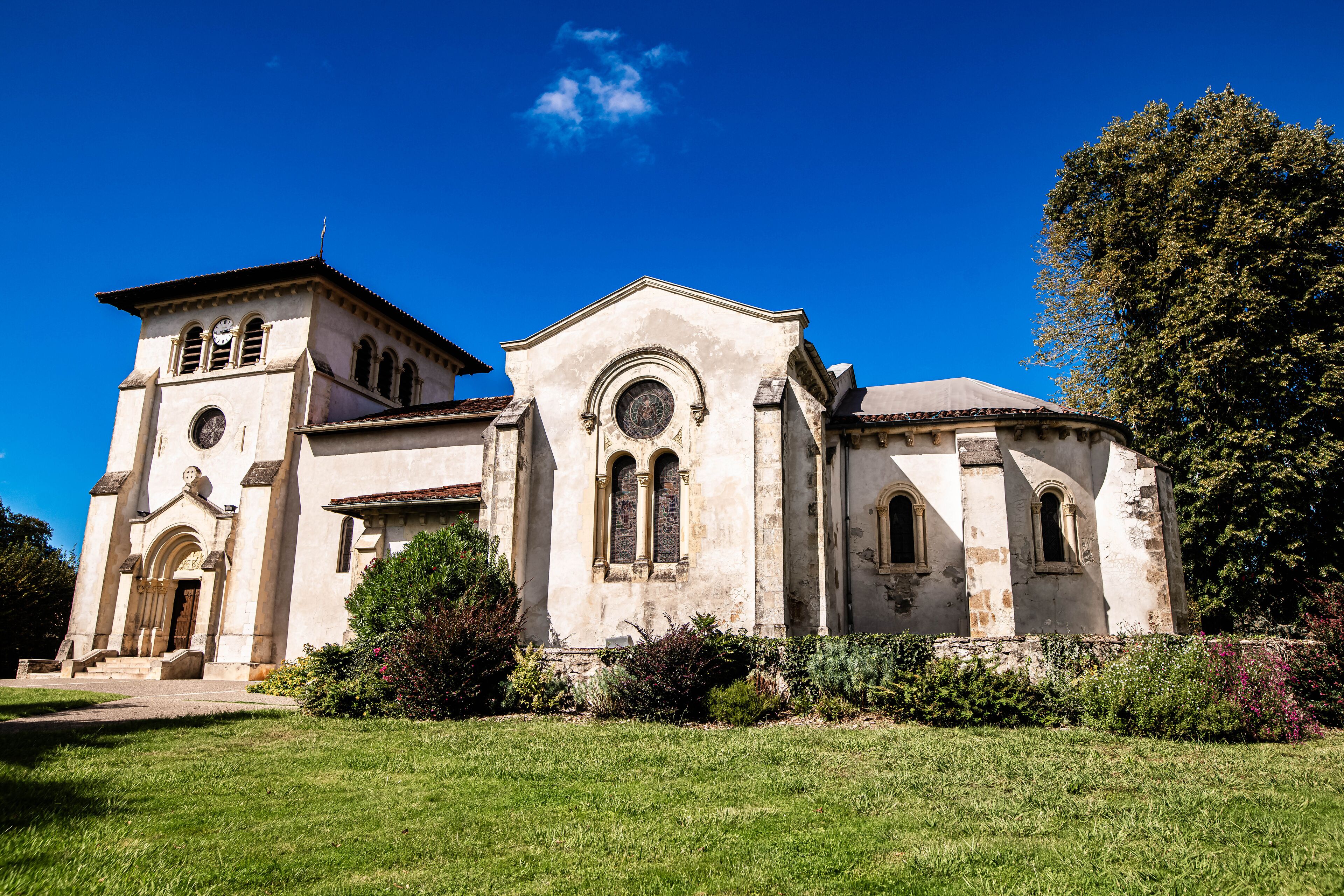 A historic church with a bell tower and arched windows.