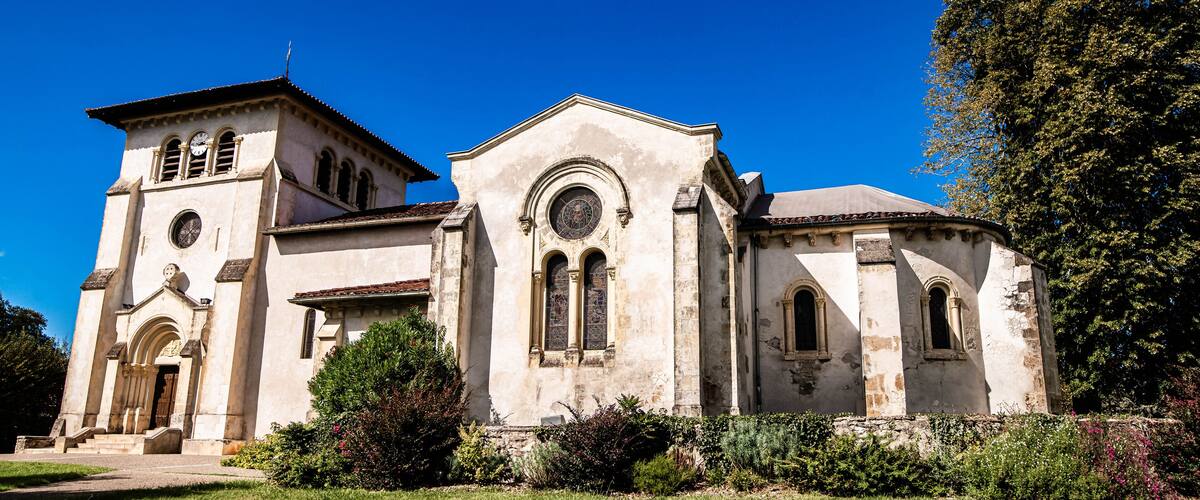 A historic church with a bell tower and arched windows.