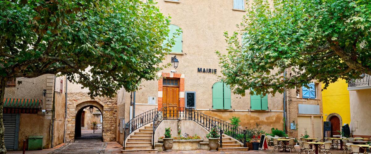 A cobblestone street with a staircase leading to a building labeled "MAIRIE."