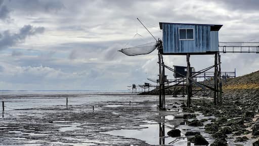 Traditional old wooden fishing huts on stilts in the Atlantic Ocean, Gironde estuary, near Talais, France