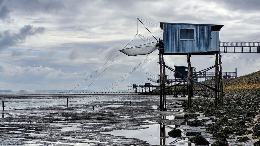 Traditional old wooden fishing huts on stilts in the Atlantic Ocean, Gironde estuary, near Talais, France