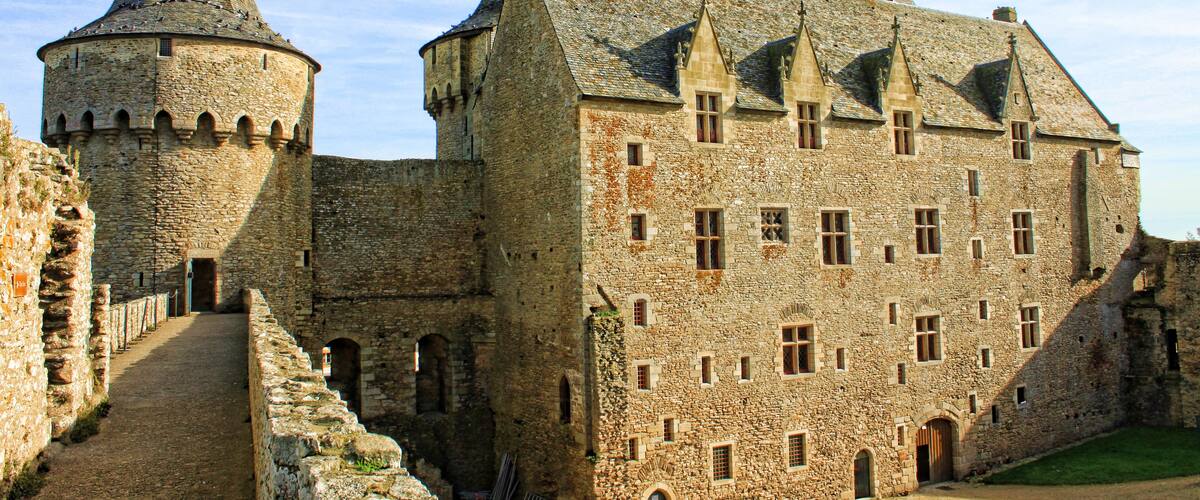 A historic stone castle with multiple towers and a large central building.