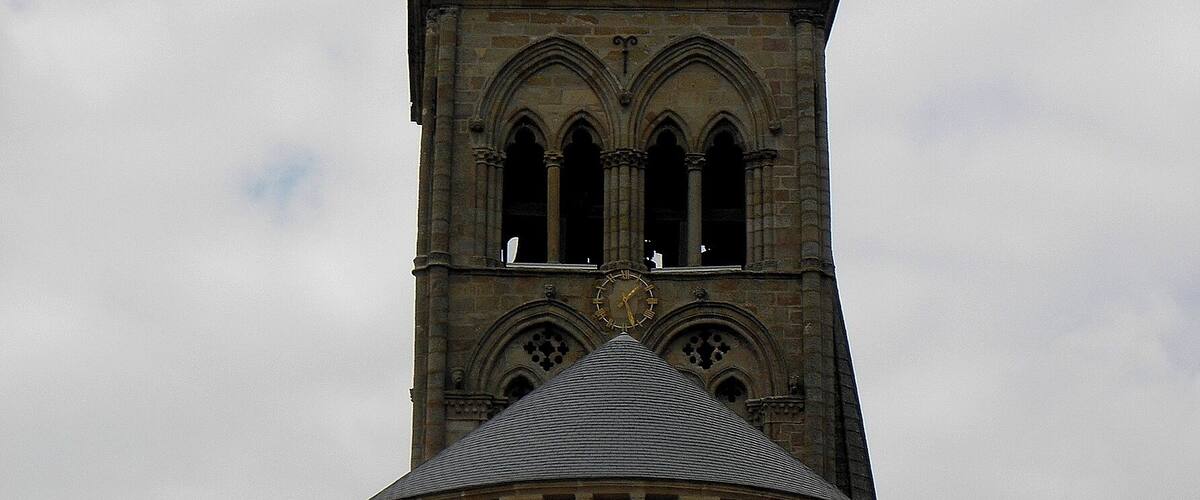 A church with a tall steeple and a clock.