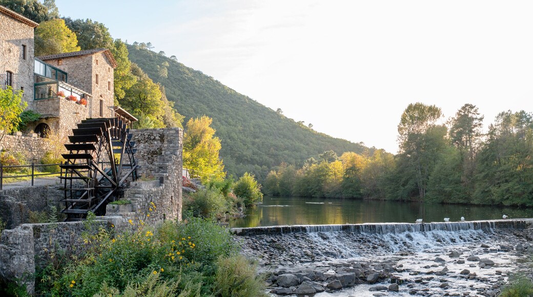 beautiful and colorful river mountain autumn fall season panoramic landscape with a watermill at sunset