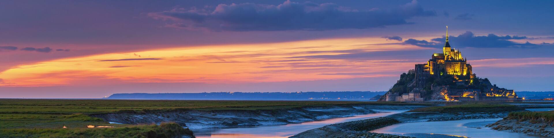 Panoramic view of famous Le Mont Saint-Michel tidal island at sunset, Normandy, northern France