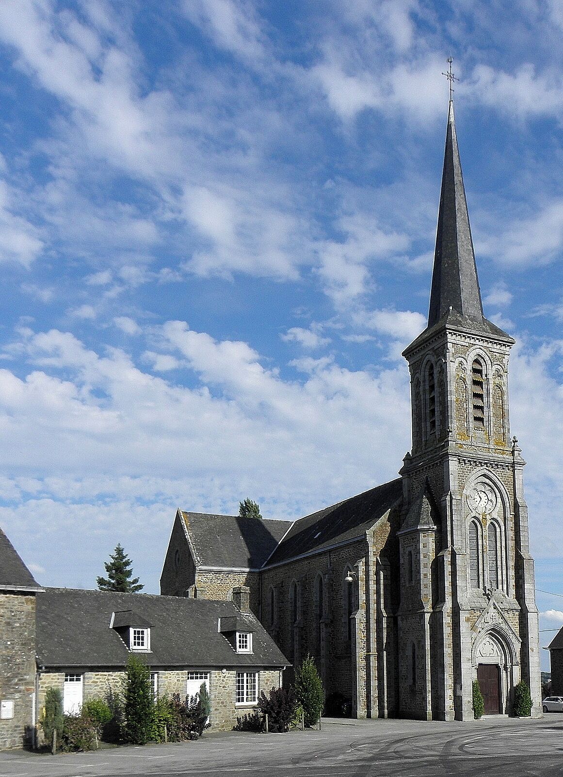 A church with a tall steeple and a clock tower.