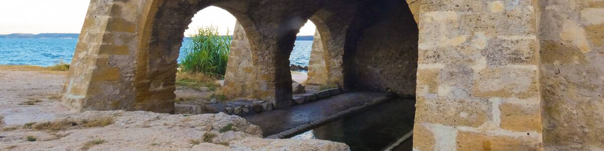 Magnificent old stone wash house from the 18th century called wash house of contagious on the edge of the Berre pond in Saint-Chamas in Provence in France