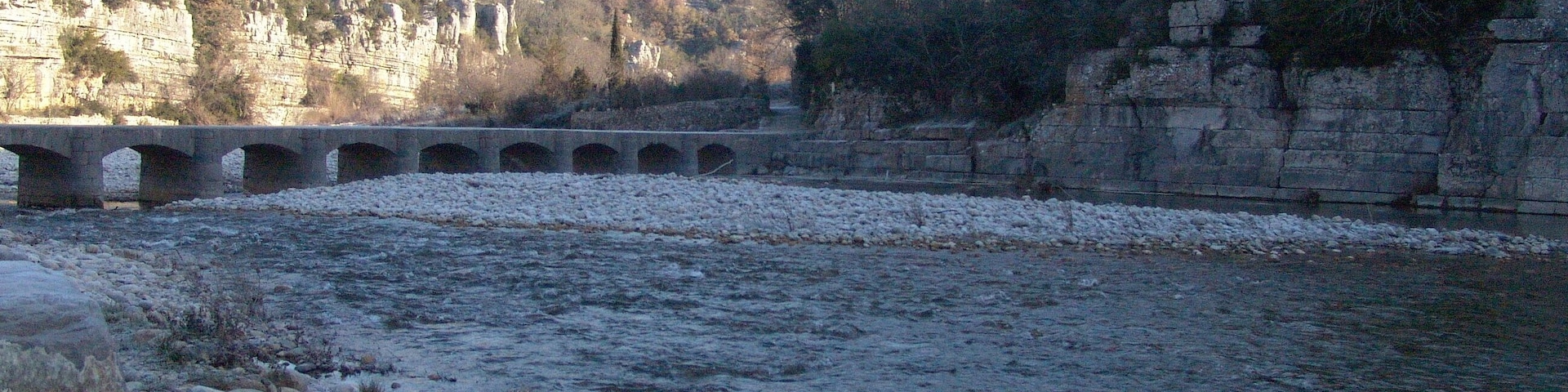 The river La Baume and stone gateway of Labeaume.