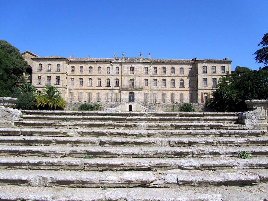 Un edificio histórico con una amplia escalera que conduce a su entrada.
