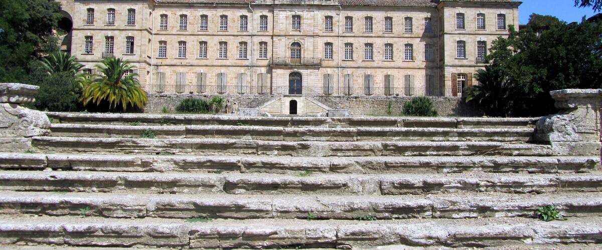 A historic building with a large staircase leading up to its entrance.