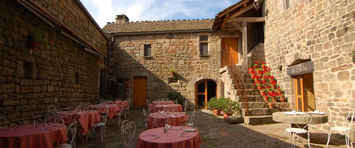 The courtyard restaurant at the Auberge La Régordane in La Garde Guérin France. One of the best al fresco #restaurant experiences we've ever had. #france #ardeche #cevennes #europe #food http://www.acooknotmad.com/2011/09/on-the-road-to-ardeche.html #roadtrip