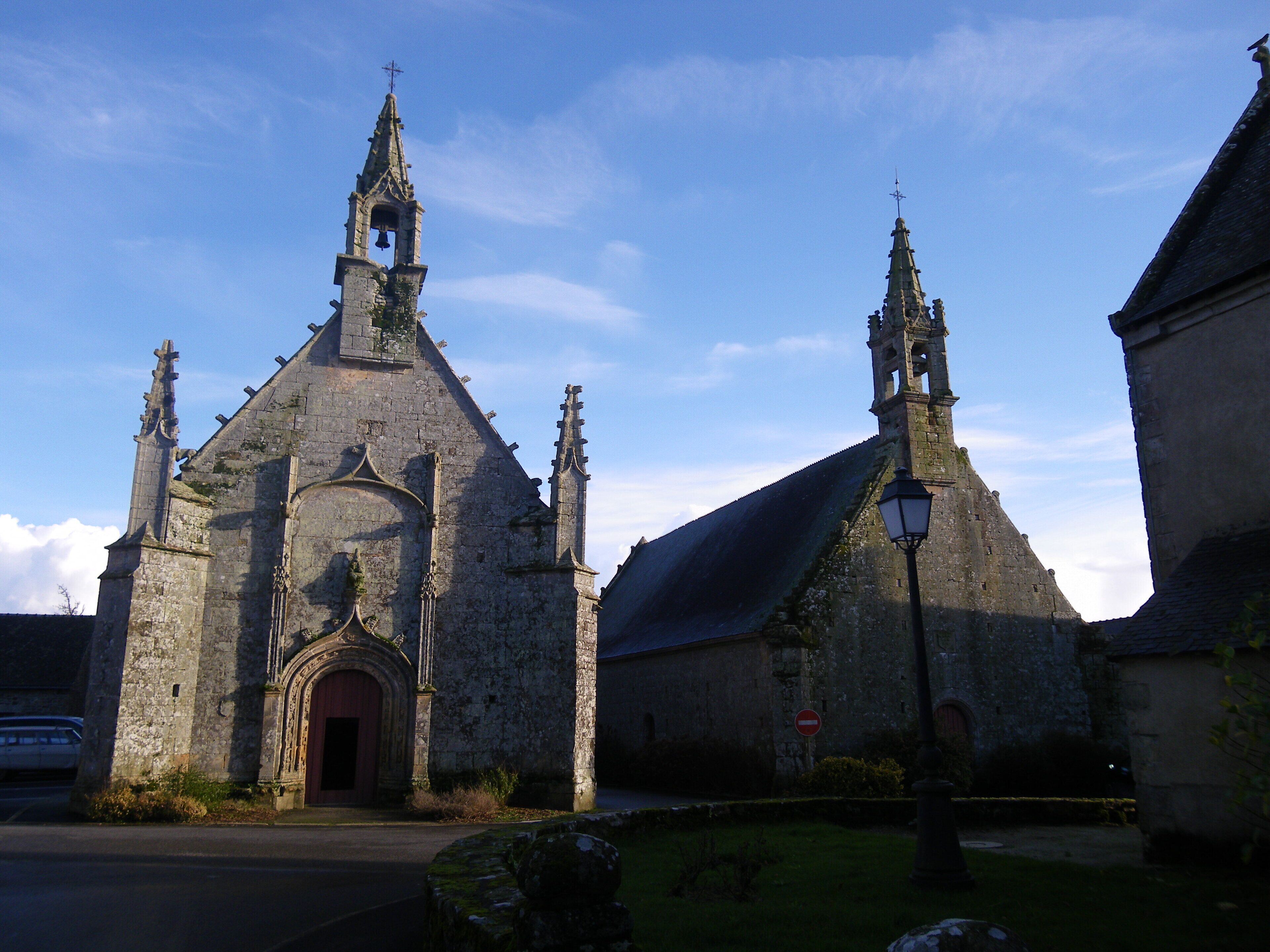 A historic church with a bell tower and a large arched entrance.