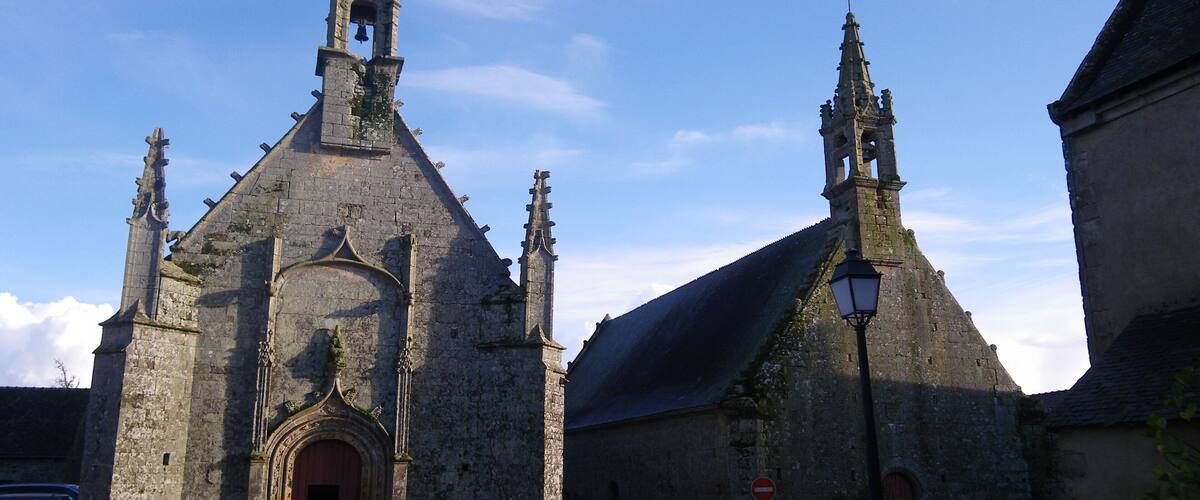 A historic church with a bell tower and a large arched entrance.
