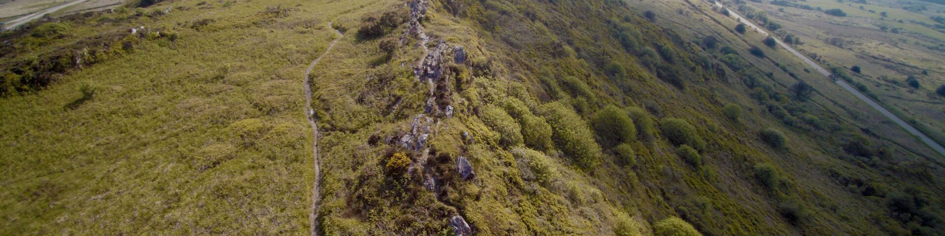A mountainous landscape with a winding path.