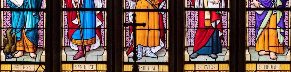 Ploumilliau (Plouilio), France. Stained glass window in St Miliau Church depicting saints John, Melor, Milliau, Ivo and Peter