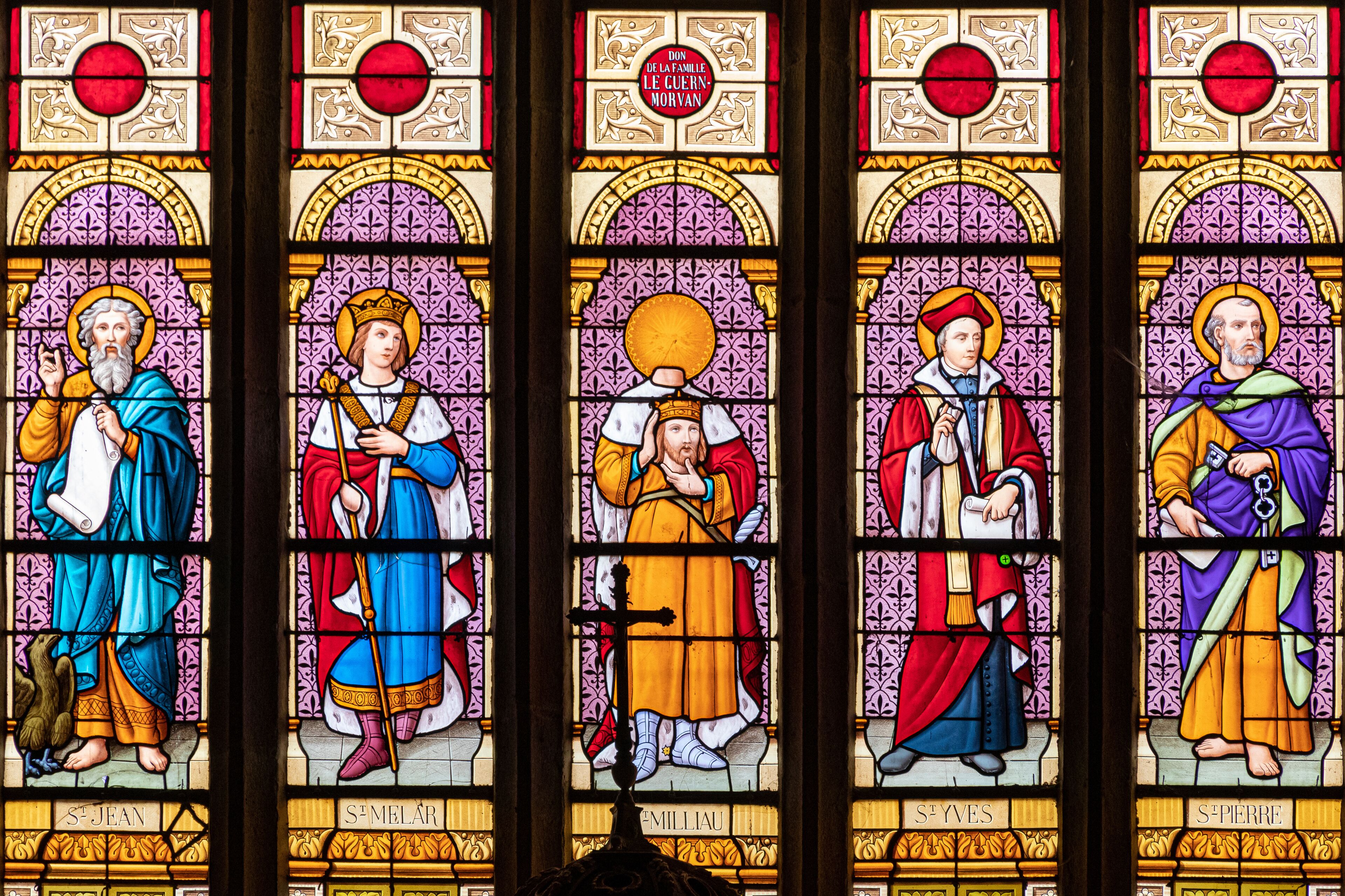 A stained glass window with saints.