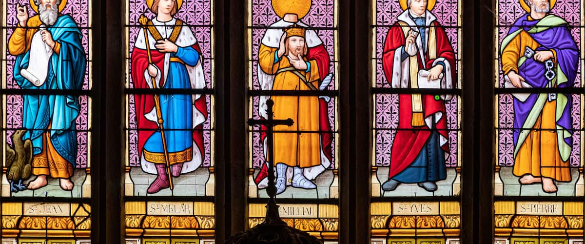 A stained glass window with saints.