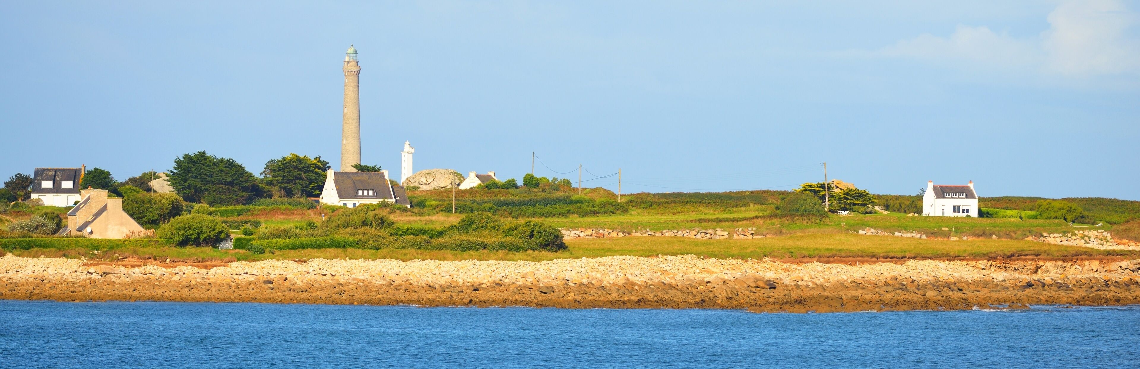 Panoramic view of the Île Vierge lighthouse against clear blue sky. Brittany, France. Architecture, travel destinations, tourism, vacations, national landmark, sightseeing