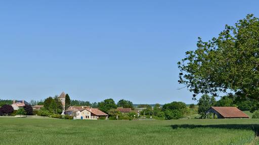 Road D 458 and west view of the village of Pillac, Charente, France.