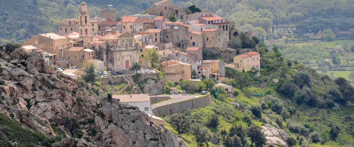 A hillside village with historic stone buildings and a prominent church.