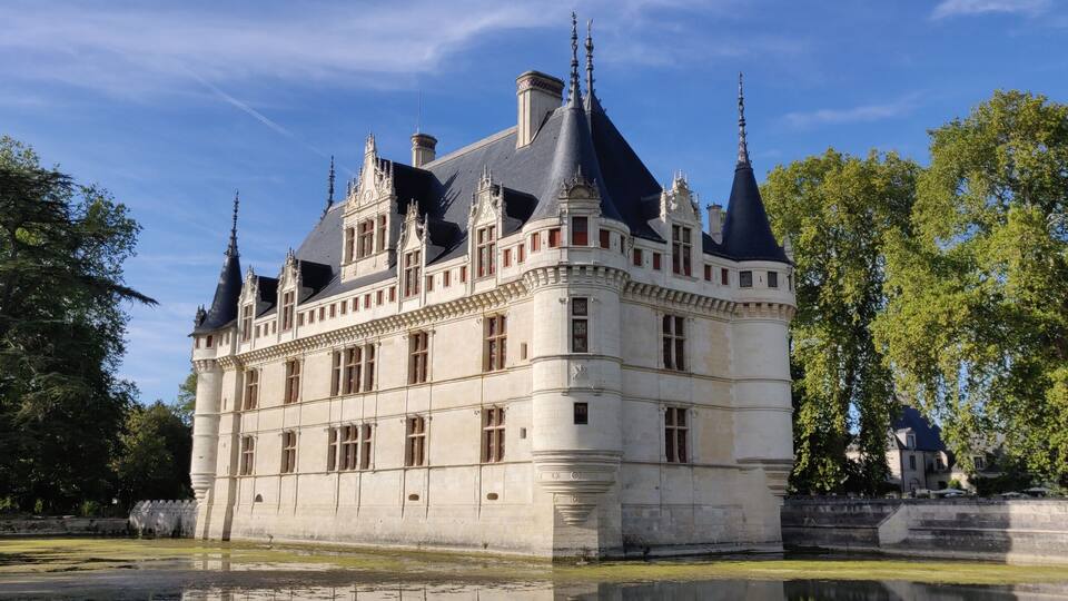 A historic château with multiple towers and a moat.