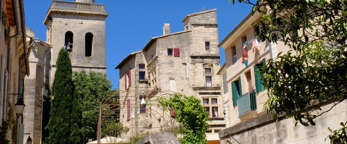 A historic town with a prominent church tower, narrow streets, and traditional stone buildings.