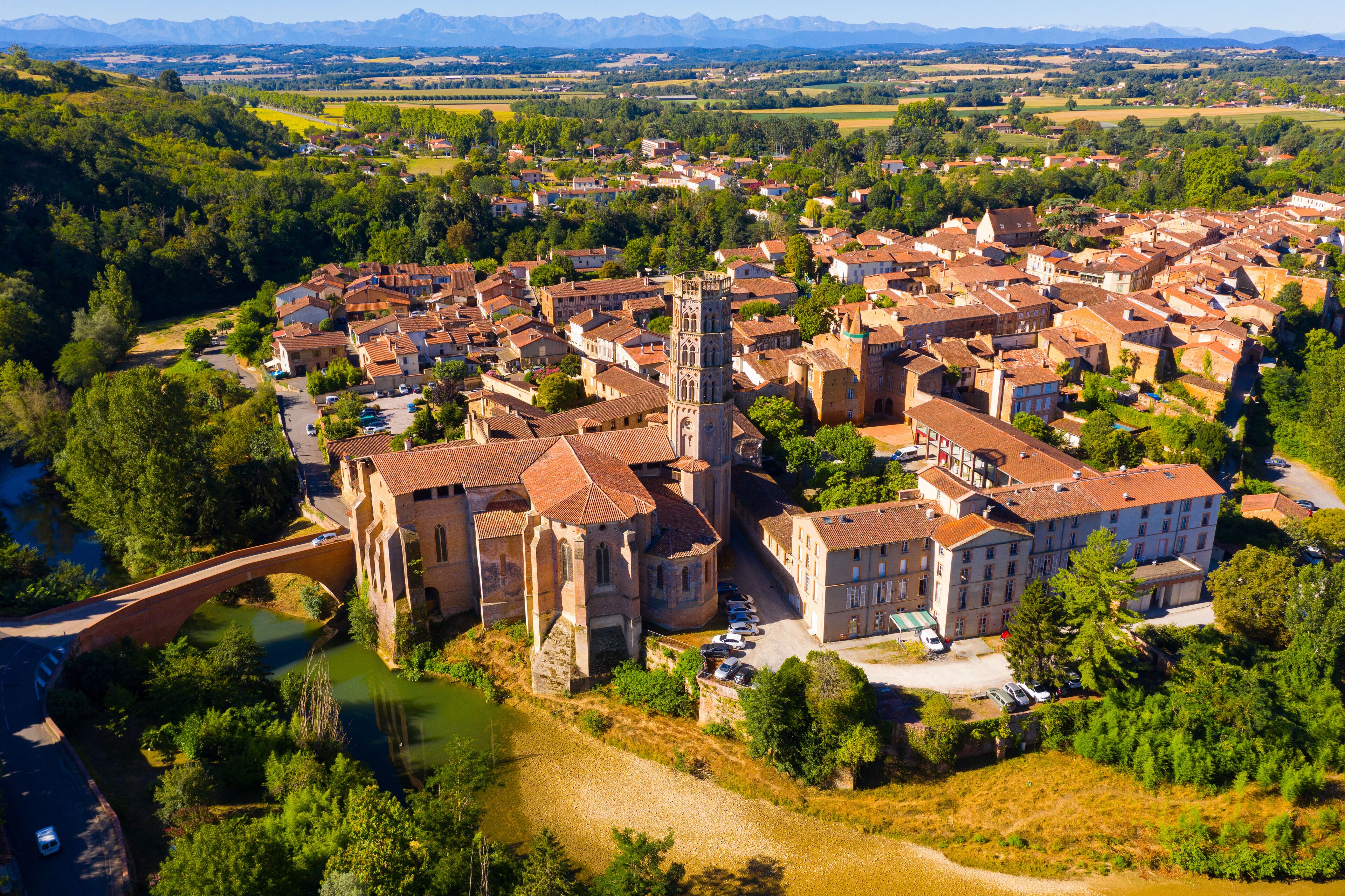 A town with a prominent church and a bridge over a river.