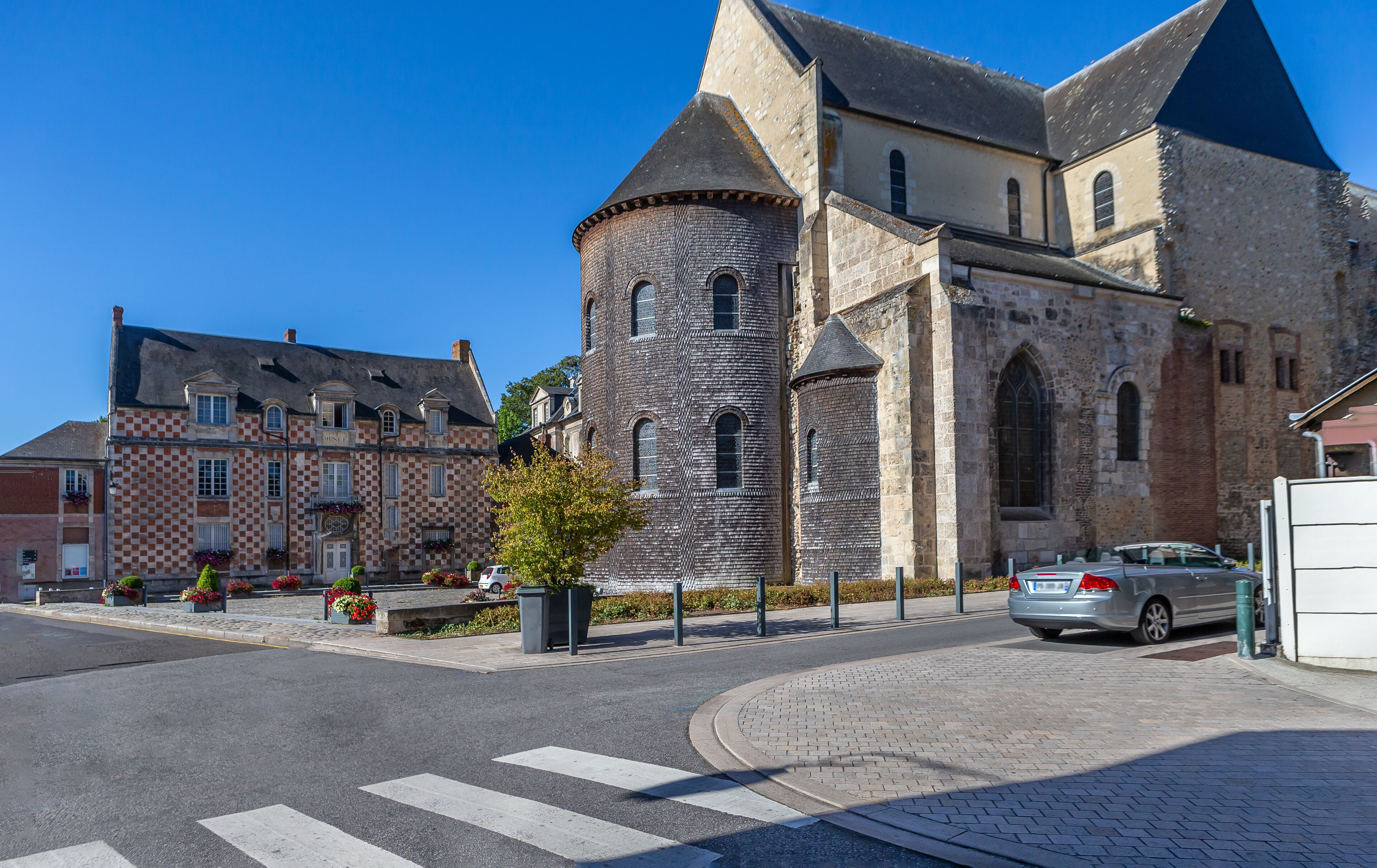 A historic church with a prominent tower and a checkered facade.