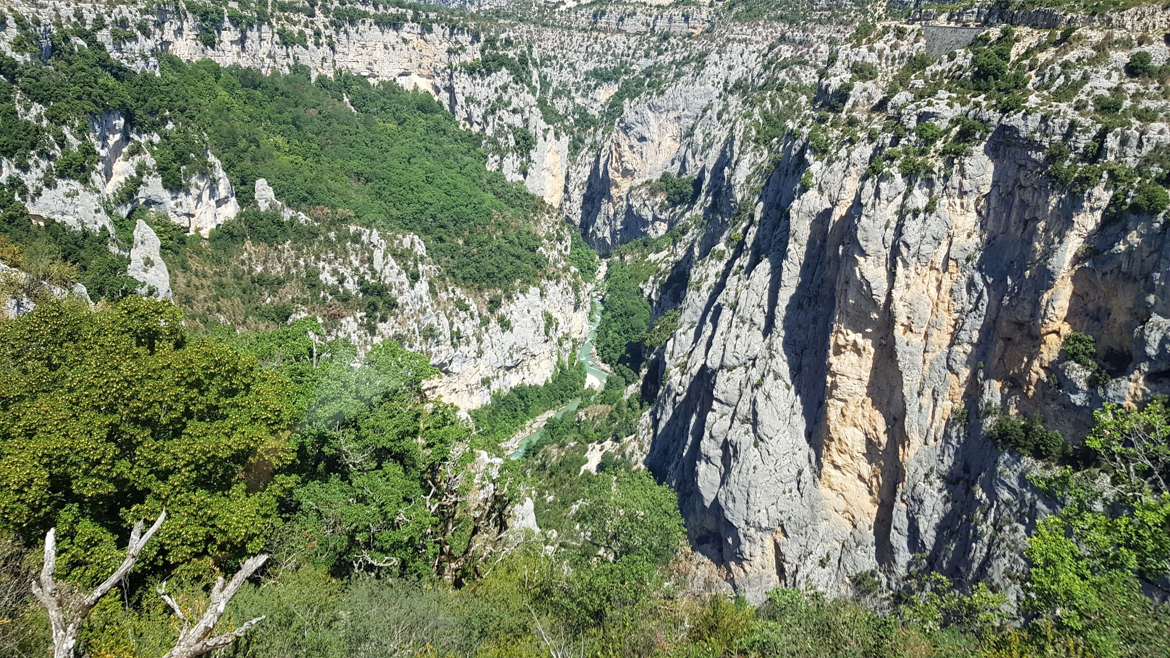A rugged mountain landscape with steep cliffs and dense greenery.