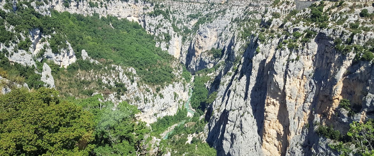 A rugged mountain landscape with steep cliffs and dense greenery.