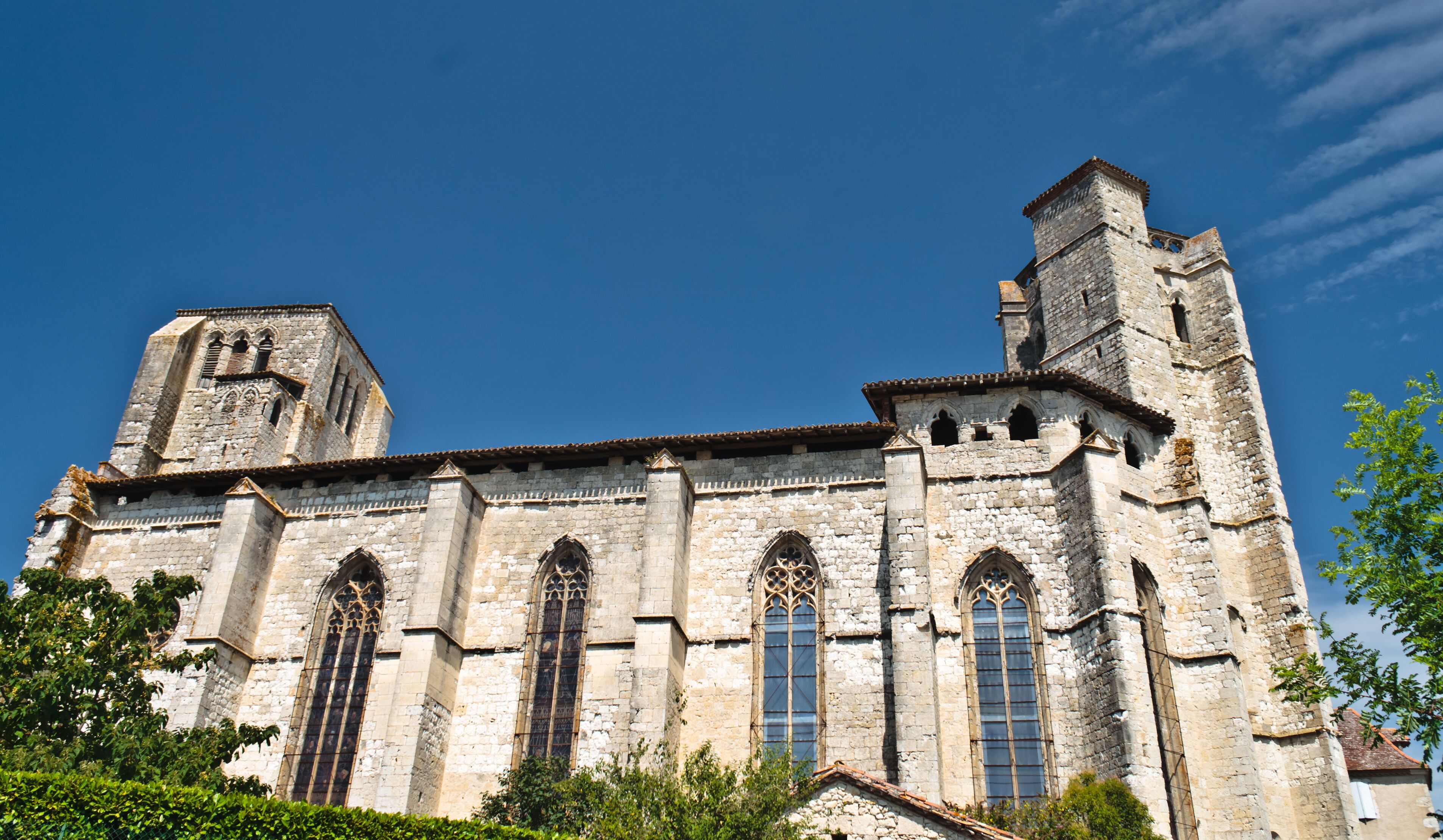 A historic stone church with tall bell towers and large arched windows.