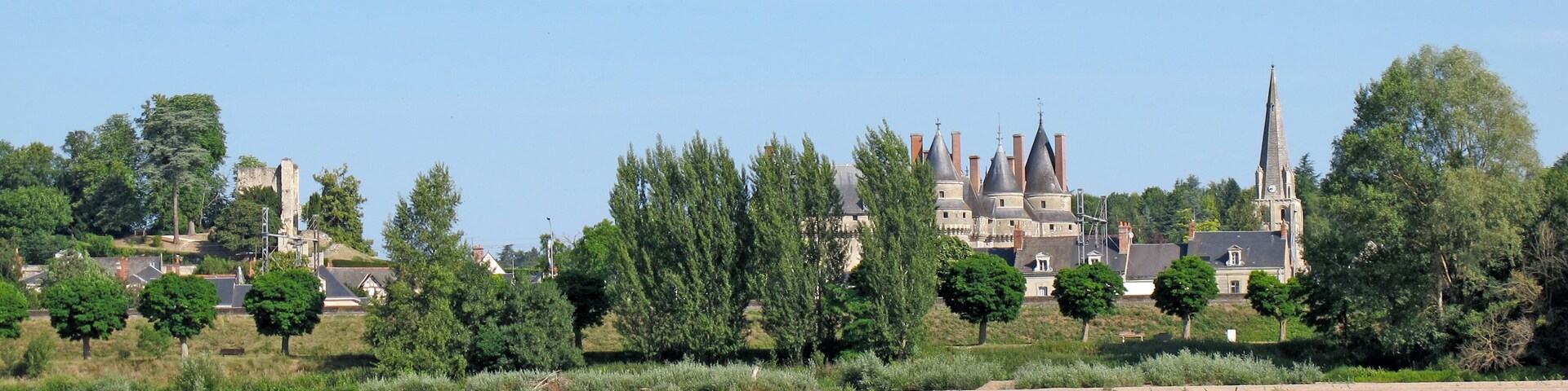 A river with a castle and church in the background.