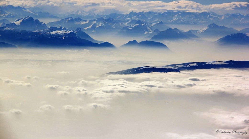 When my flight flying above the the mountains peaks and clouds, I can see the mountains peaks peeping out of the fogging and swirling mist with the white clouds floating around the mountains it look heavenly. #mountains #France #nationalpark #travel #snow #hiking #clouds #mountainscape #nature