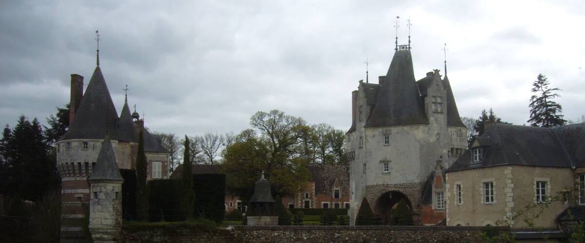 A historic castle with multiple towers and a moat.