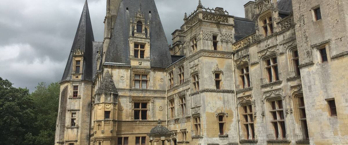 A large, historic building with multiple towers and intricate architectural details.