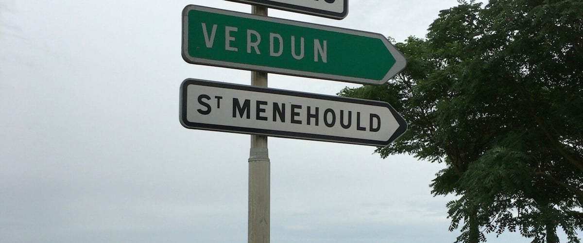 A directional signpost with multiple signs pointing to destinations such as Châlons en Ch., Courtils, Verdun, and St Menehould.
