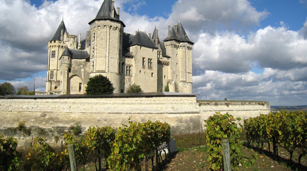 A historic castle with multiple towers and a surrounding wall.