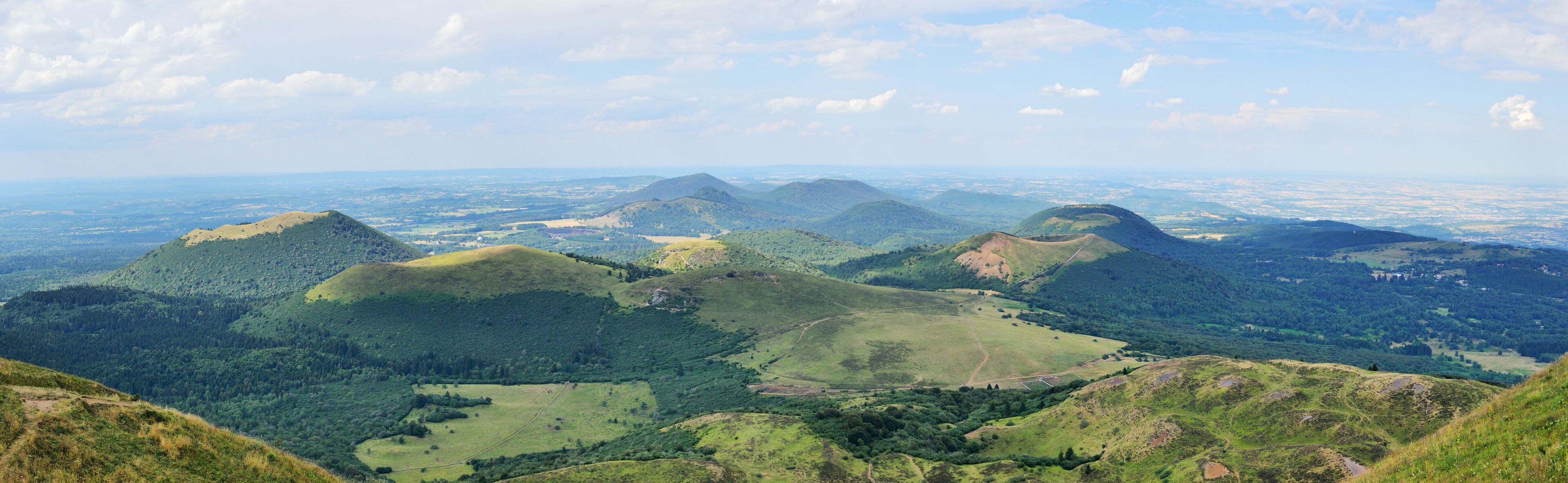 A panoramic view of rolling hills and dense forests.