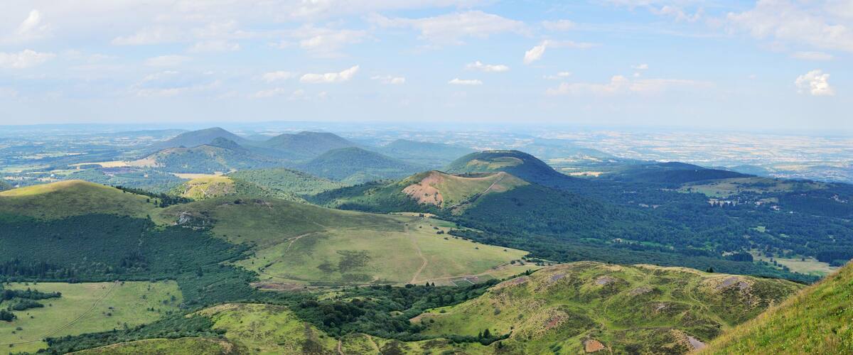 A panoramic view of rolling hills and dense forests.