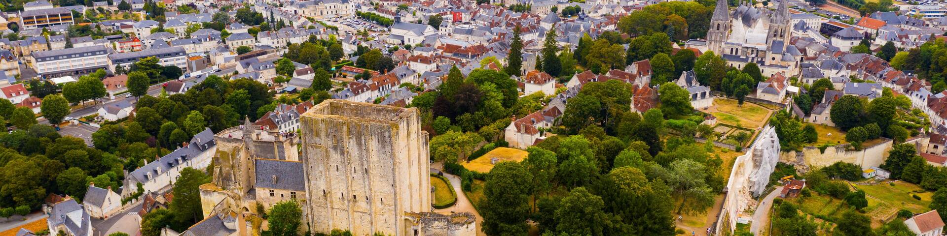Scenic drone view of medieval fortified castle with royal residence and St Ours church in historic French town of Loches in summer..