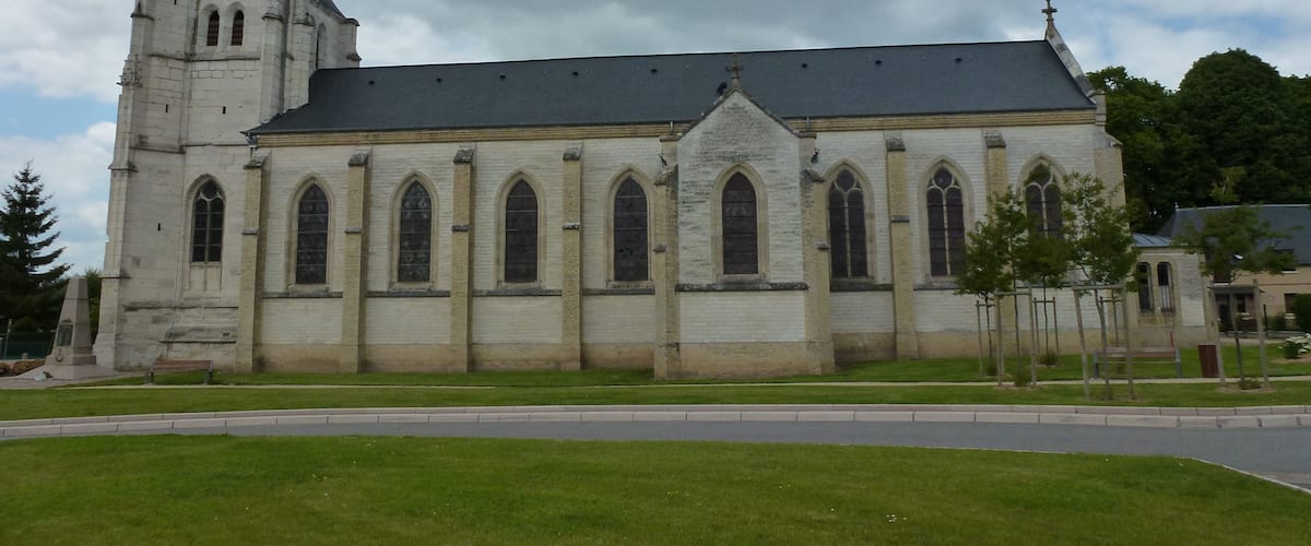 A large church with a tall tower and multiple arched windows.