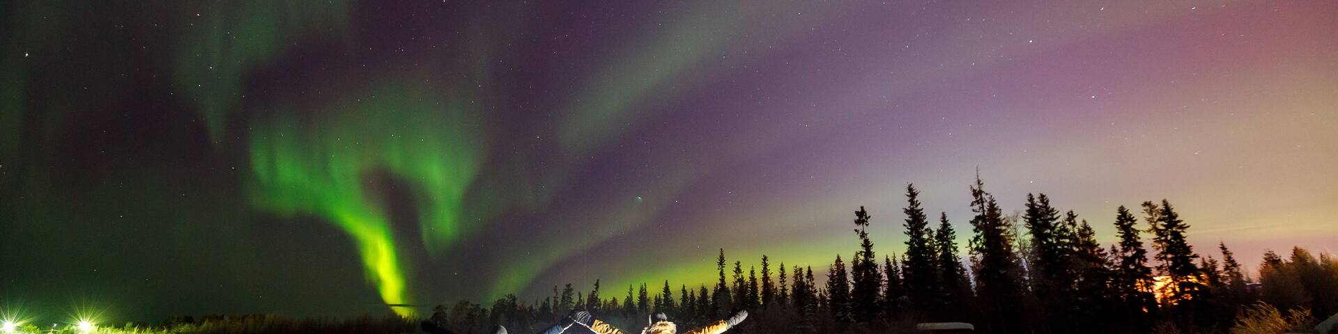 Two people Traveler in light projector on background iridescent sky