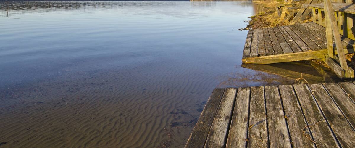 Wooden steps from Finish Sauna in the border of lake